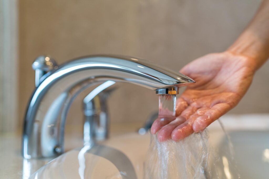 Photo Of A Hand Being Run Under A Tap